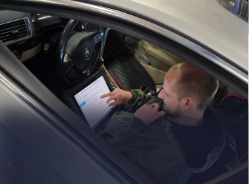 Mechanic working on a car brake rotor in a shop. | Z-1 Automotive, Inc.