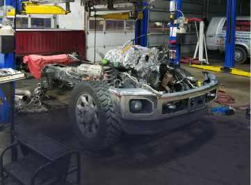 Mechanic working on a car brake rotor in a shop. | Z-1 Automotive, Inc.