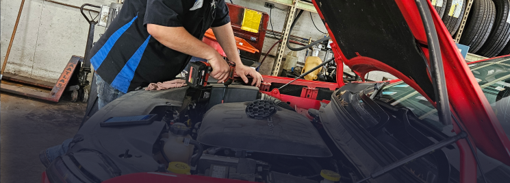 Mechanic working on a car brake rotor in a shop. | Z-1 Automotive, Inc.