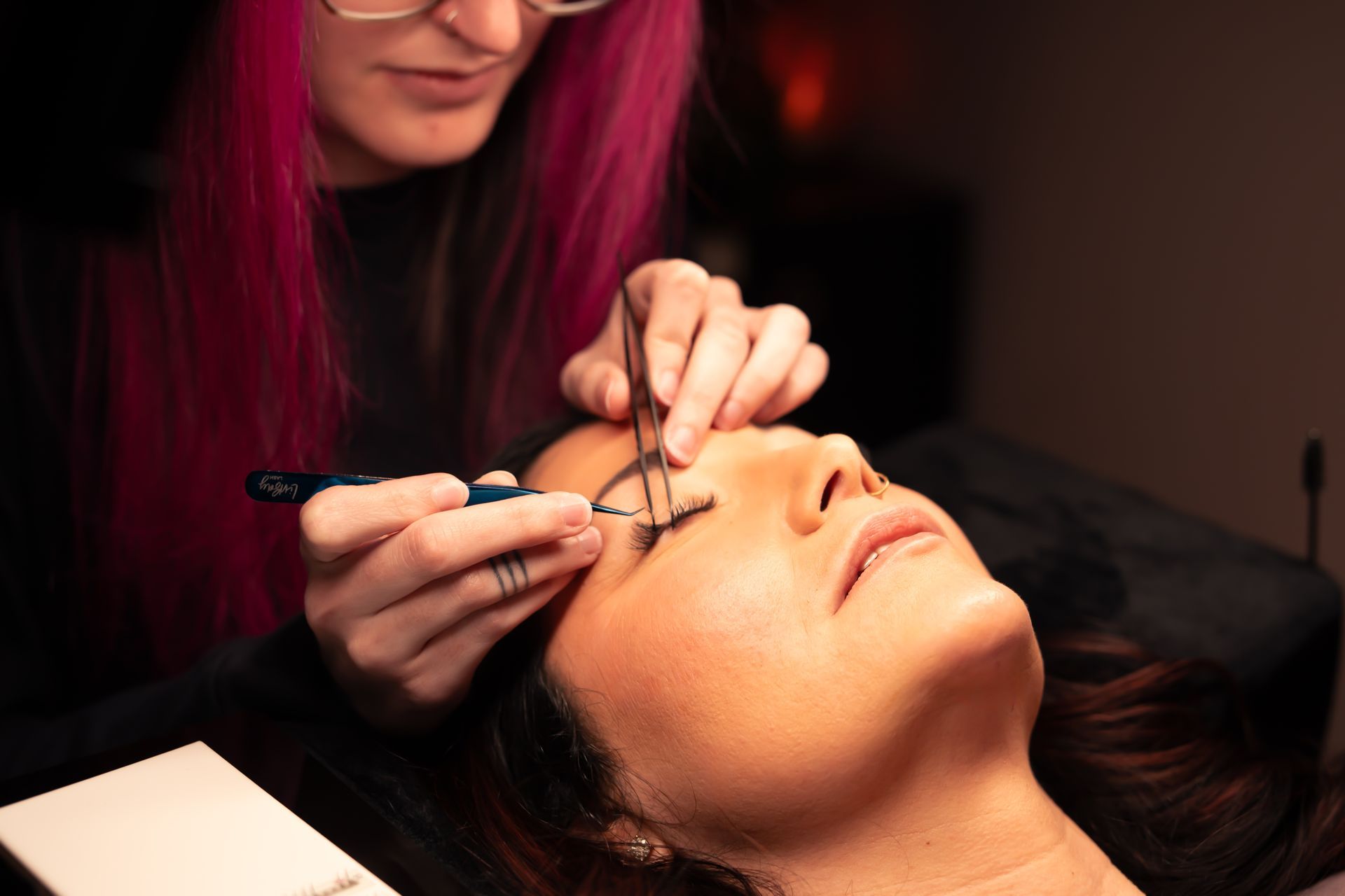 A close up of a woman 's eye with long eyelashes.