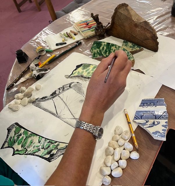 A drawing of a house with a bench in front of it