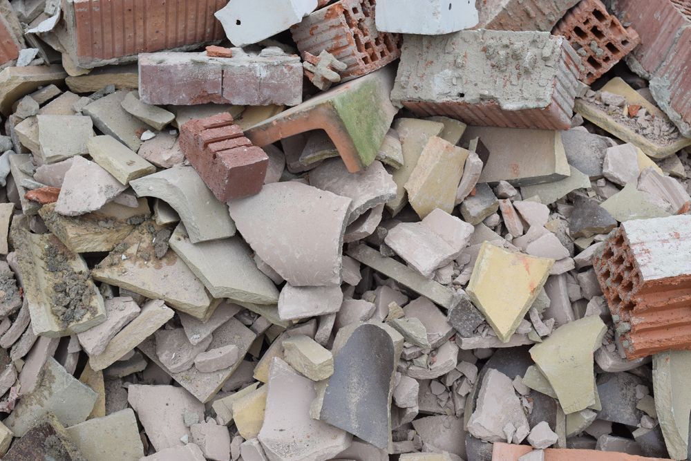 A Pile of Construction Debris Containing Scattered Red Bricks — Smiley Rubbish Removal In Thrumster, NSW