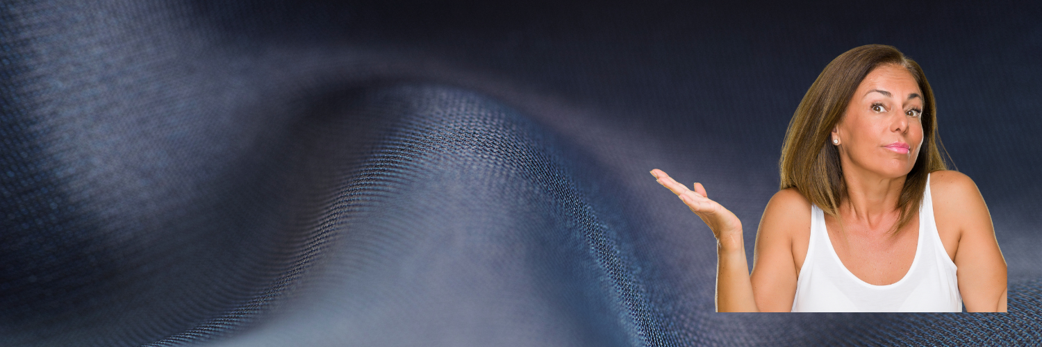A woman in a white tank top is standing in front of a blue fabric background.