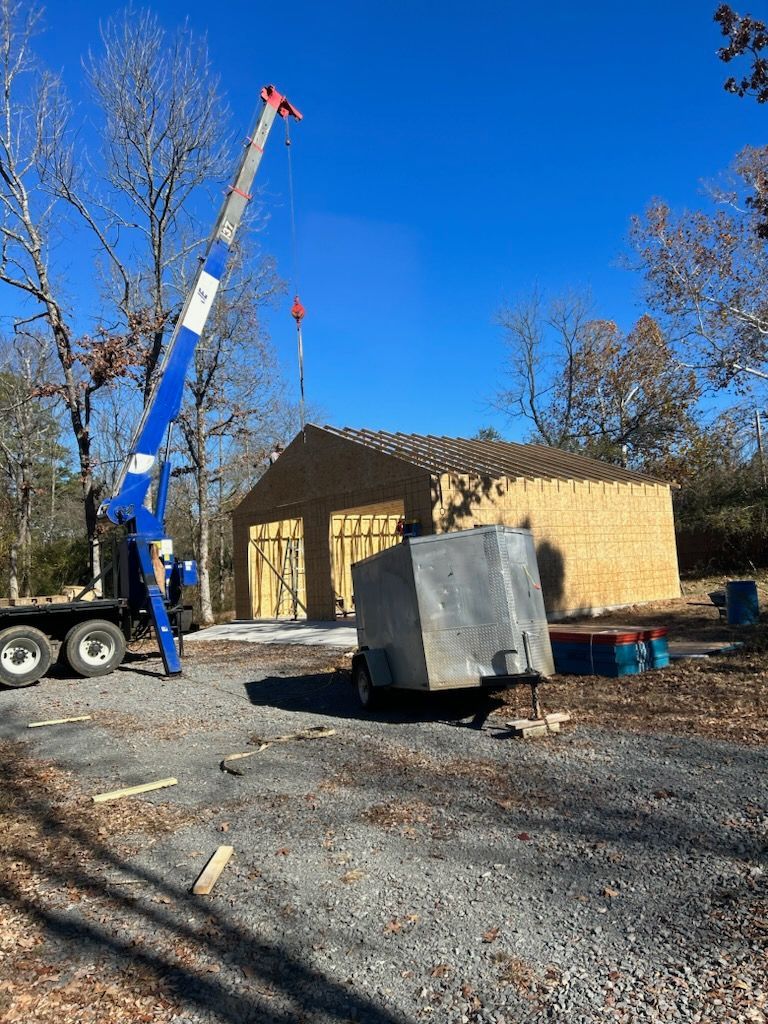 a crane is lifting a roof on a building under construction