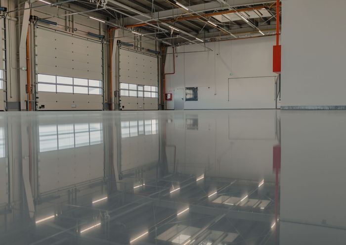 photo os a bright garage room with a shiny epoxy floor
