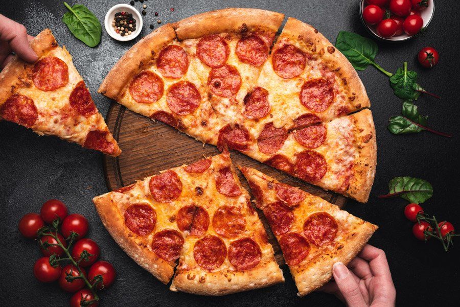 Picking Slice Of Pepperoni Pizza — Bradenton, FL — San Remo Pizza & Pasta