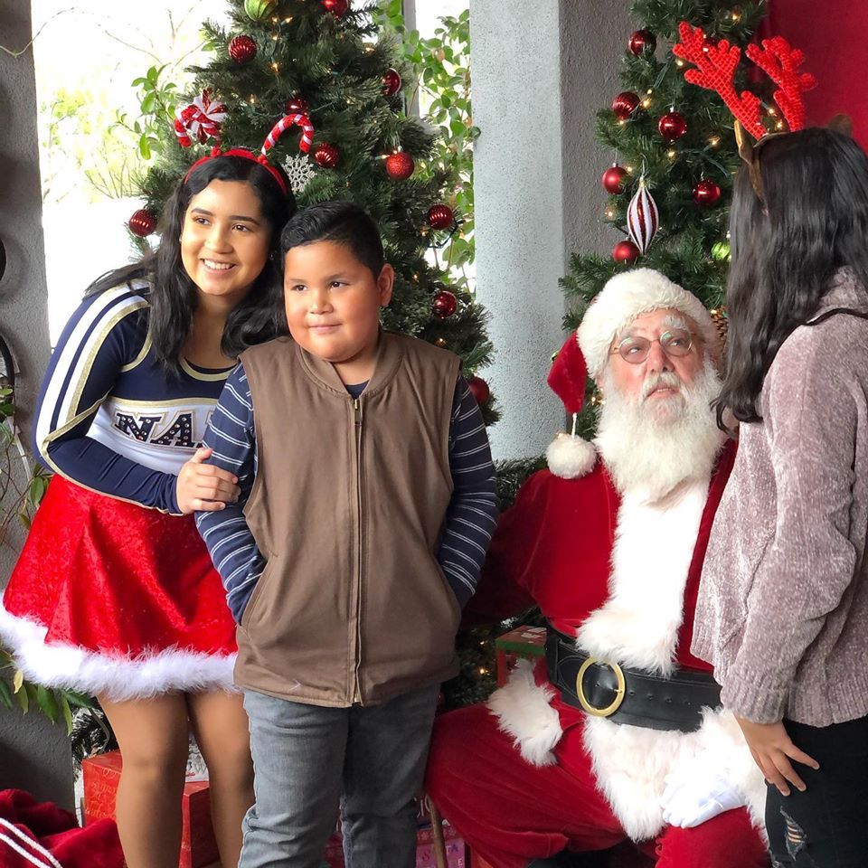 A group of children are posing for a picture with santa claus