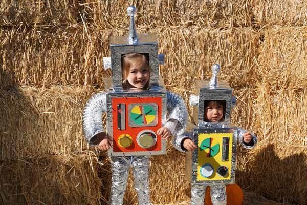 Two children dressed as robots are standing next to each other