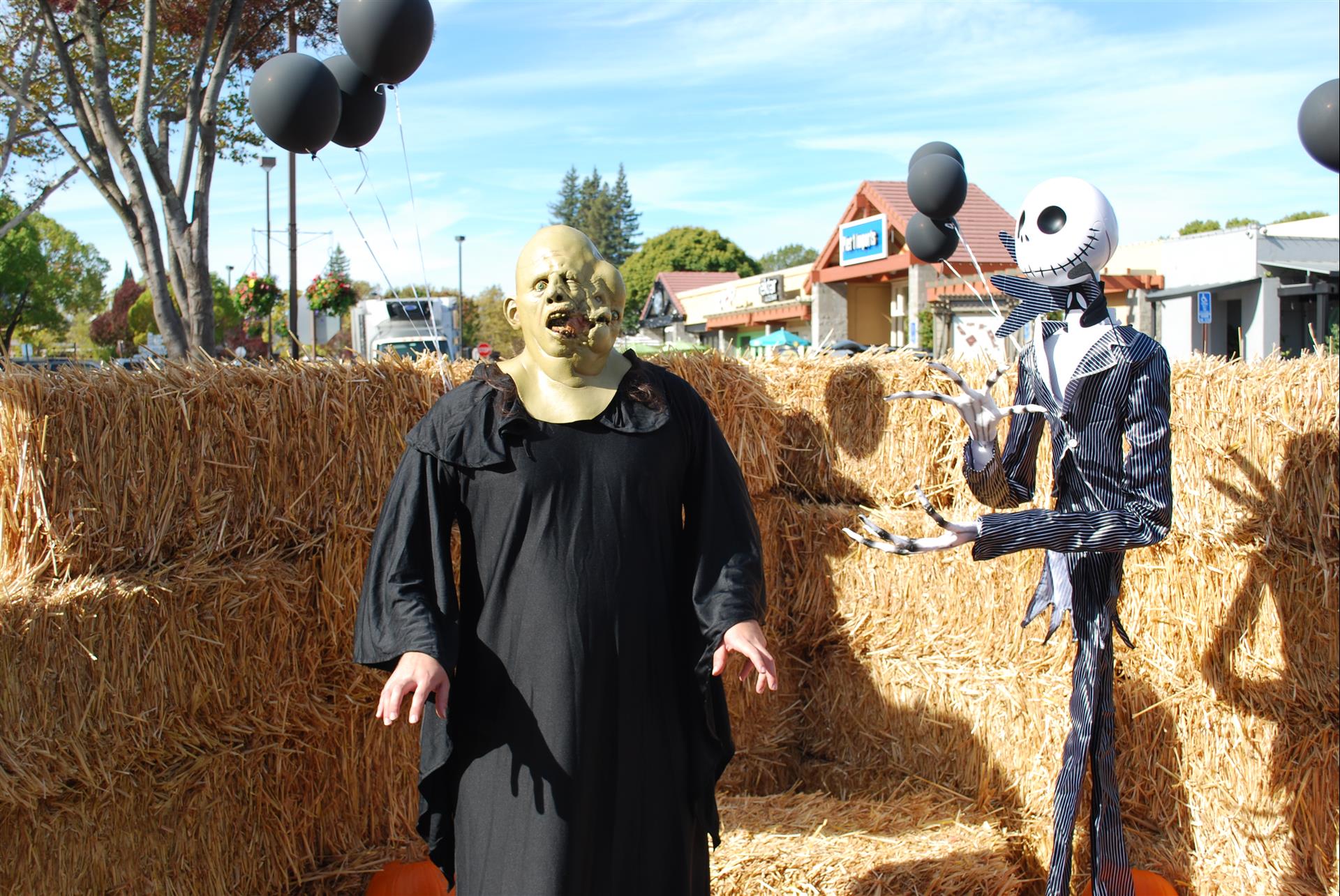 A man in a shrek mask is standing next to a skeleton