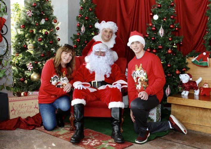 A group of people posing for a picture with santa claus