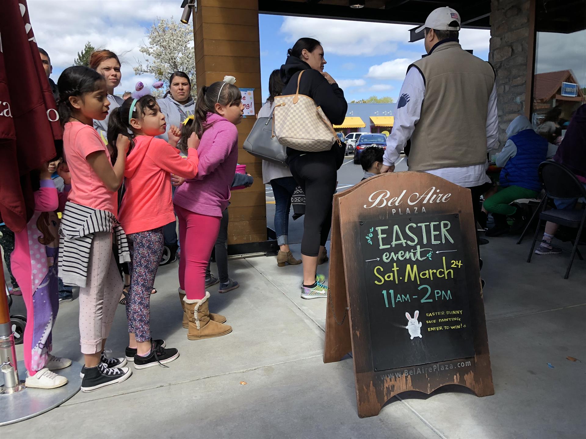 A group of people are waiting in line for an easter event