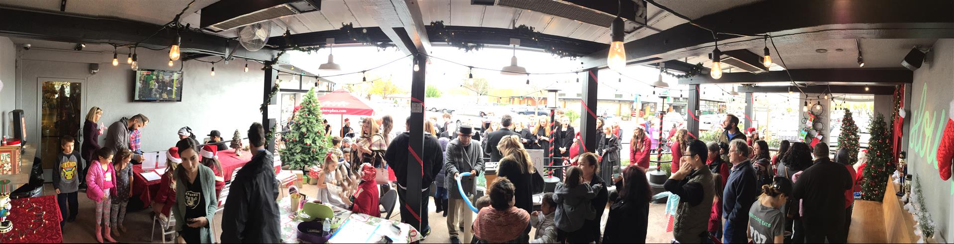 A large group of people are standing in a room.