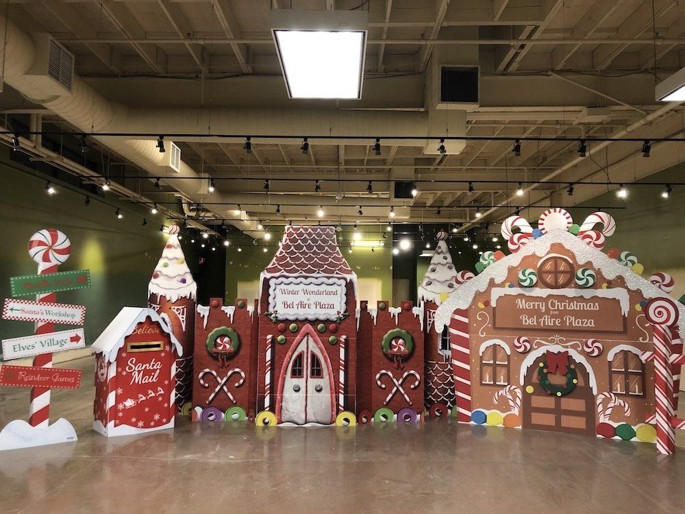 A large room filled with gingerbread houses and candy canes.