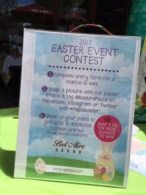 A sign for an easter event contest is sitting on a table.
