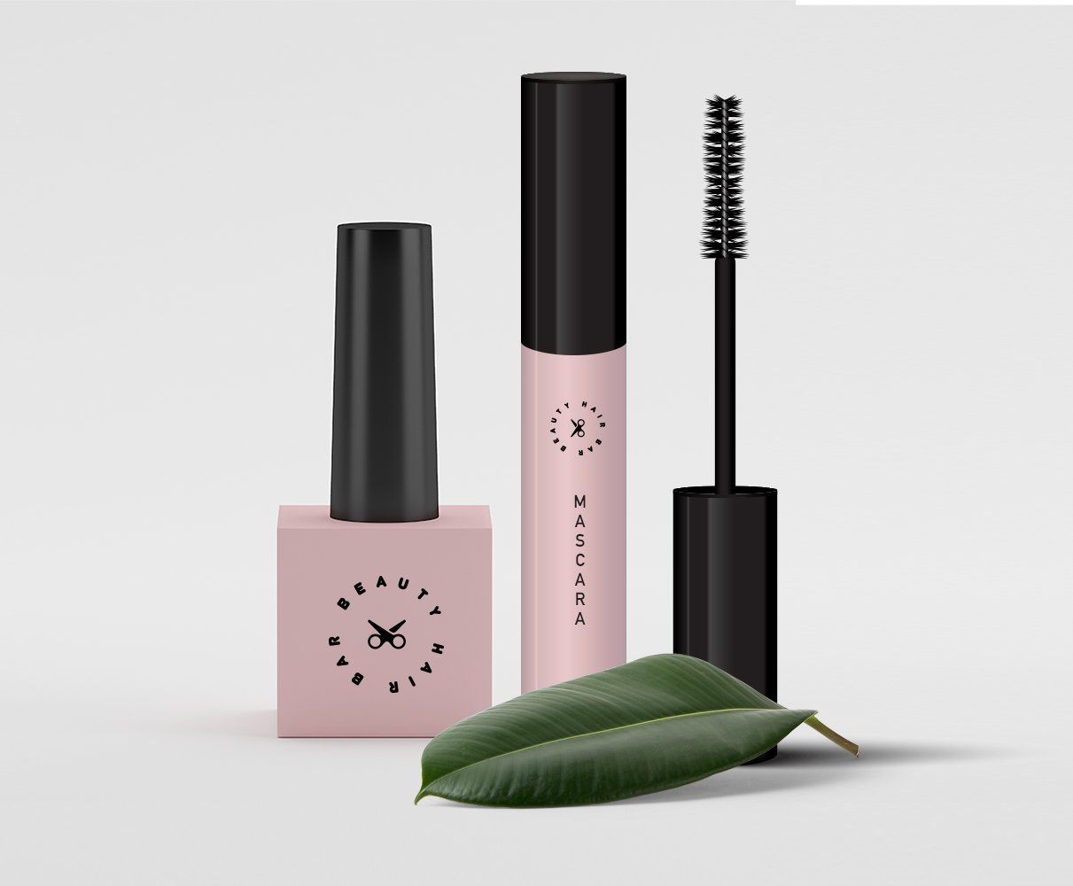 A bottle of mascara , a bottle of nail polish and a leaf on a white background.