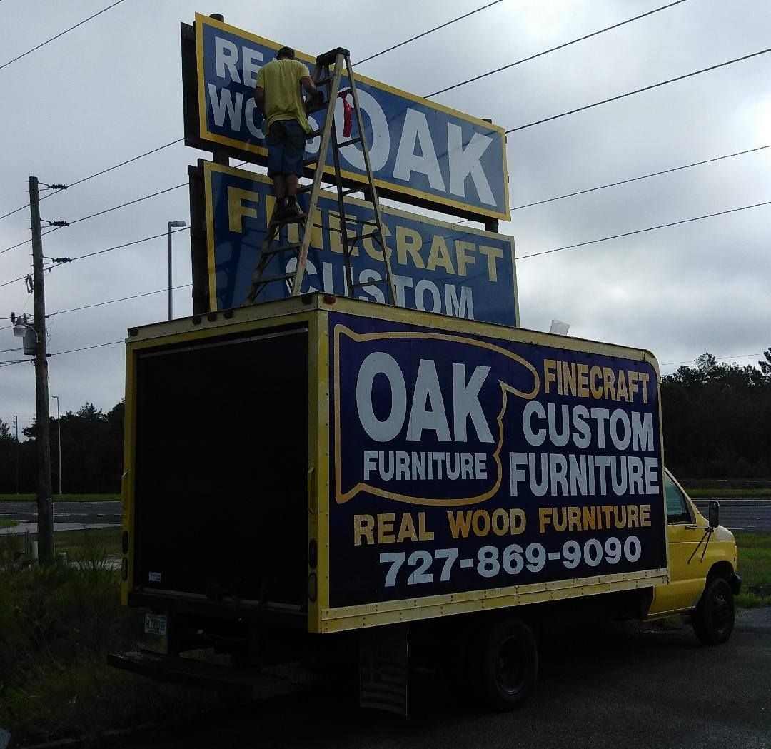 A truck with a sign on top that says oak