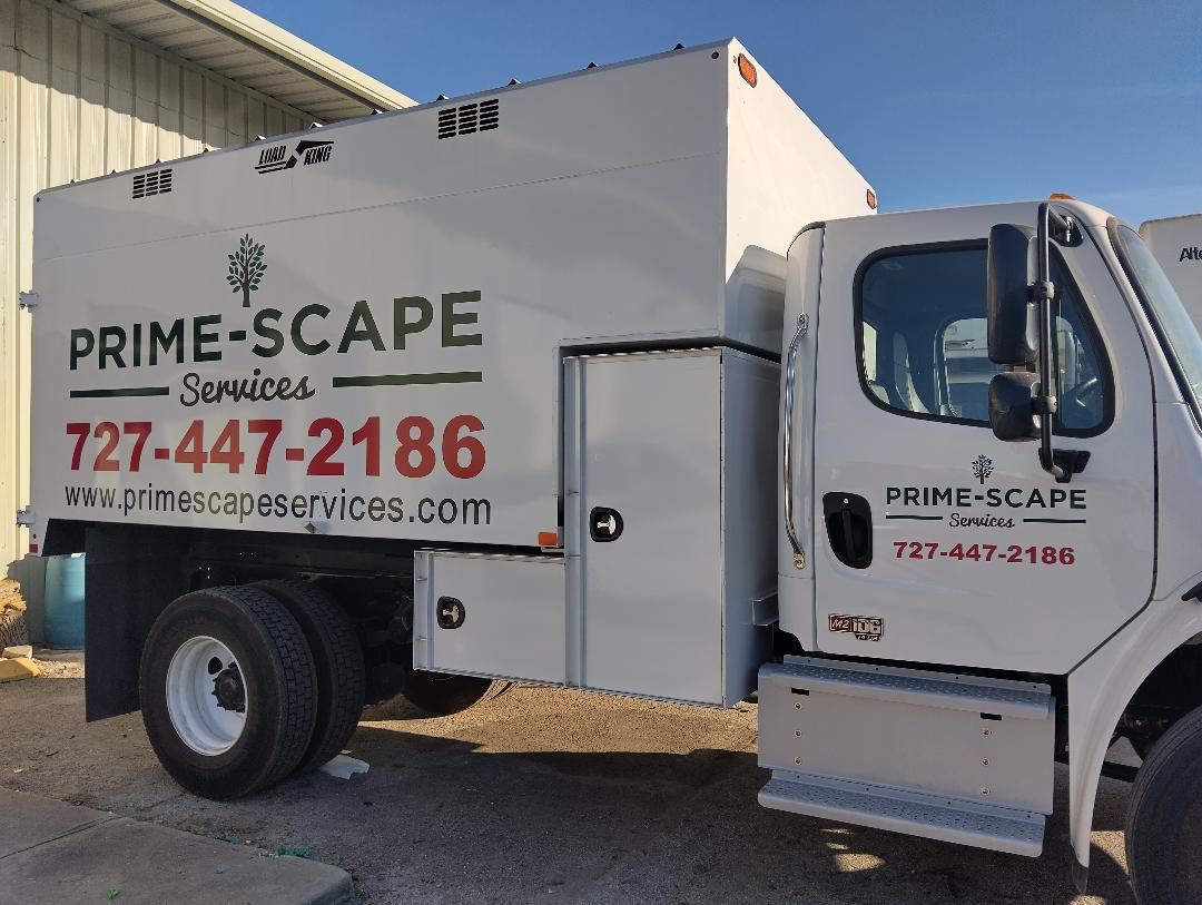 A white truck is parked in front of a building.