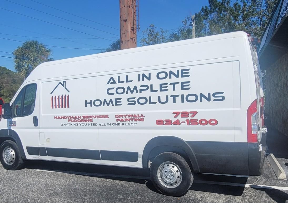 A white van that says all in one complete home solutions