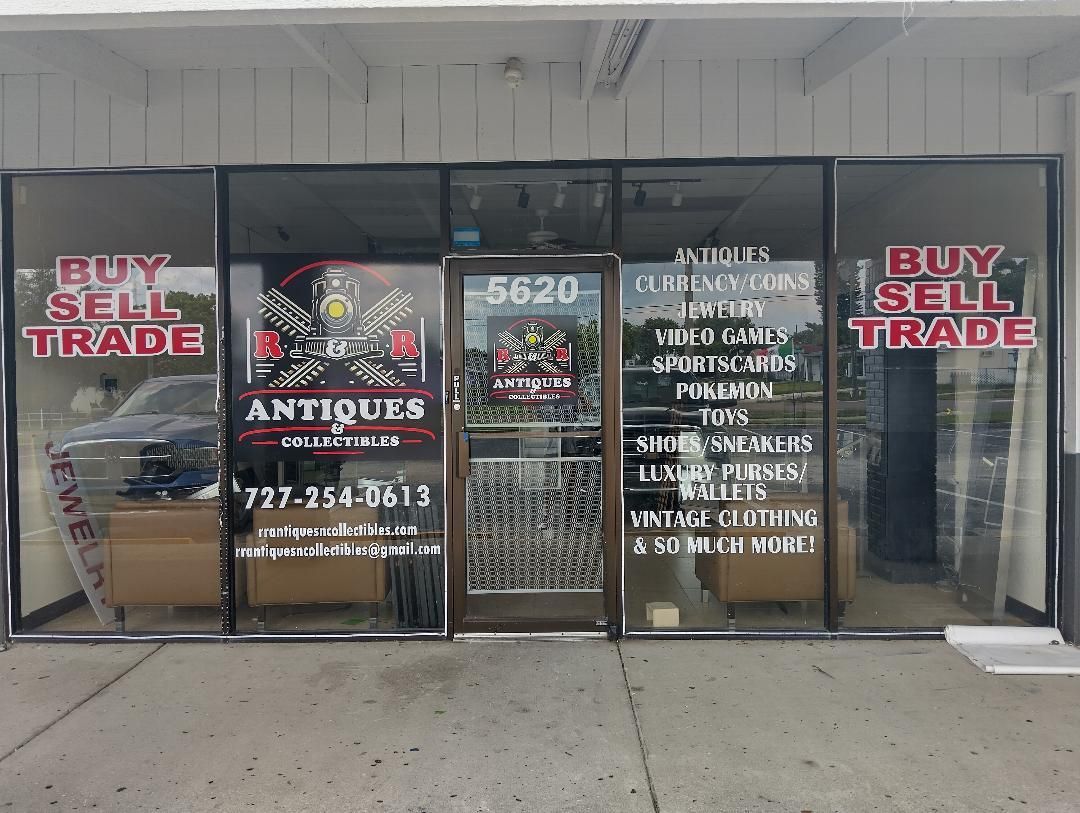 The front of a store called buy sell trade antiques.