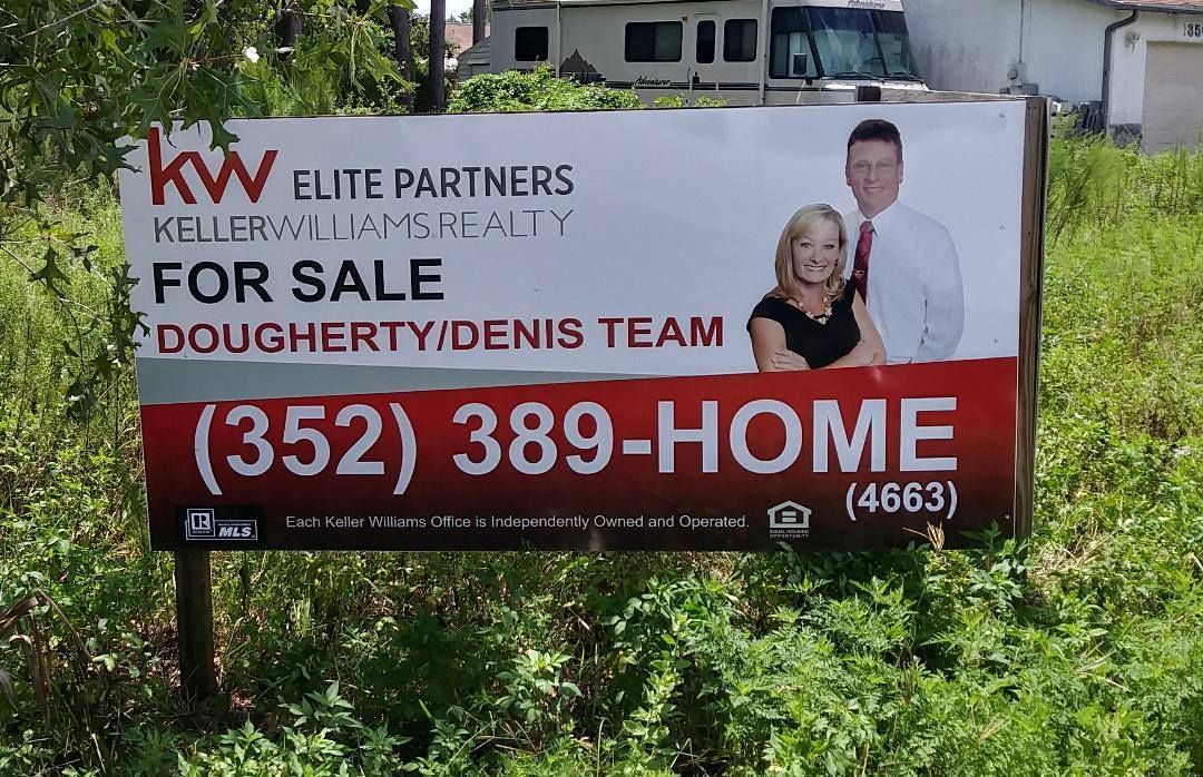 A billboard for a house for sale has the number 352 389-home on it