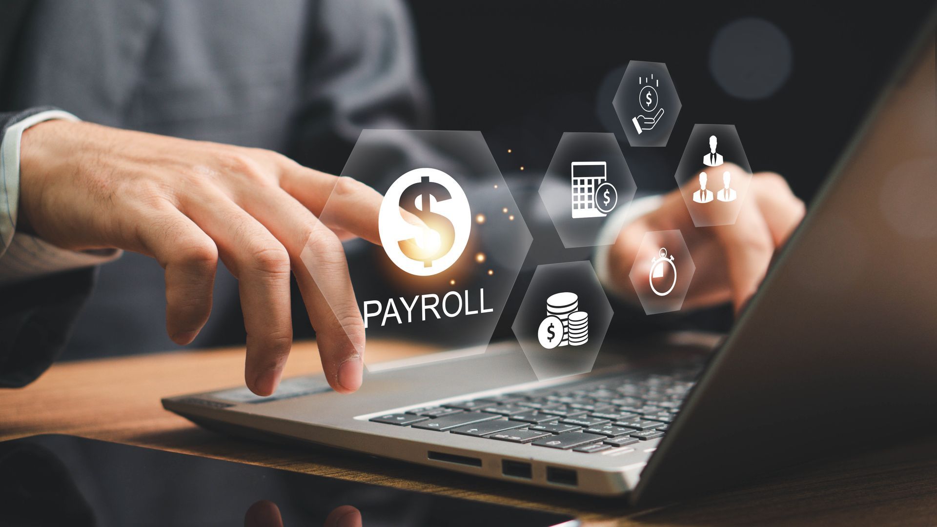 Person using laptop with payroll icon and related financial symbols.