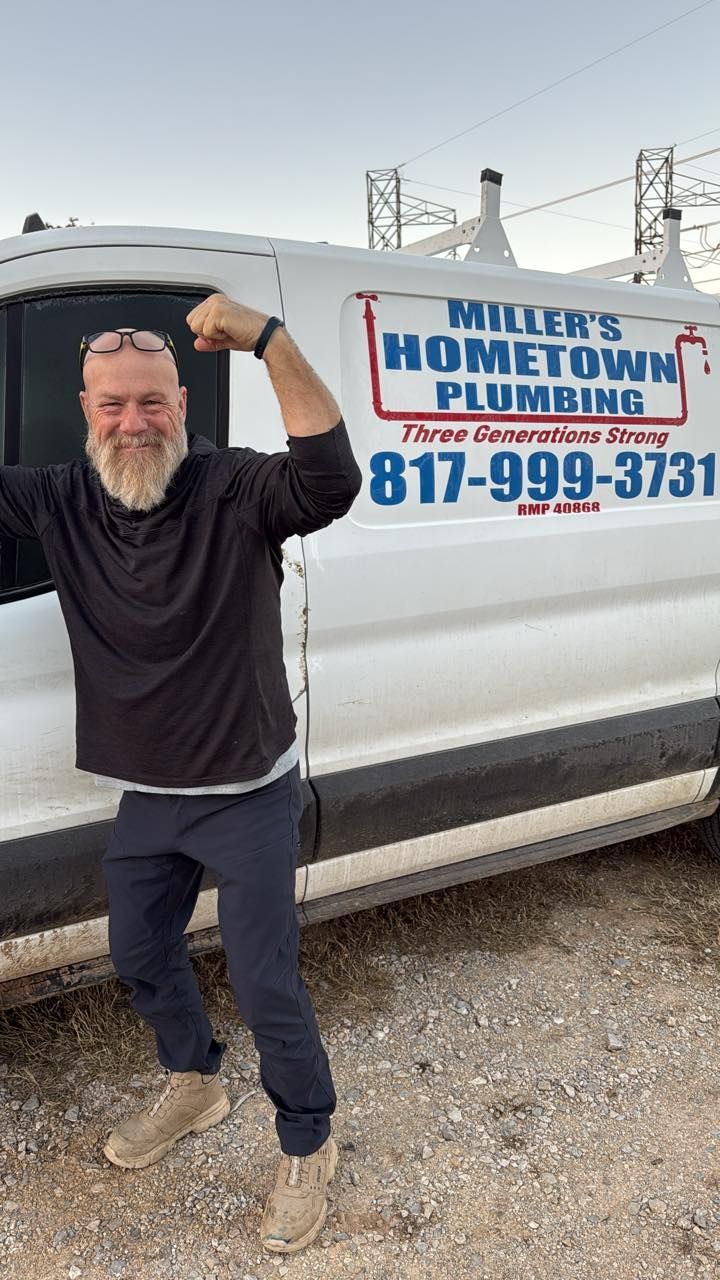 Man flexing near white plumbing van, 