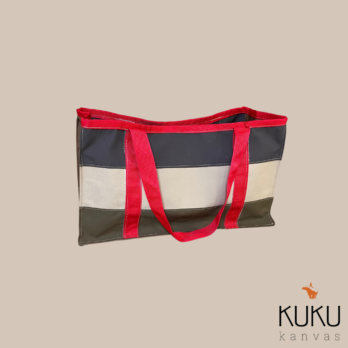 A striped tote bag with red handles from kuku canvas