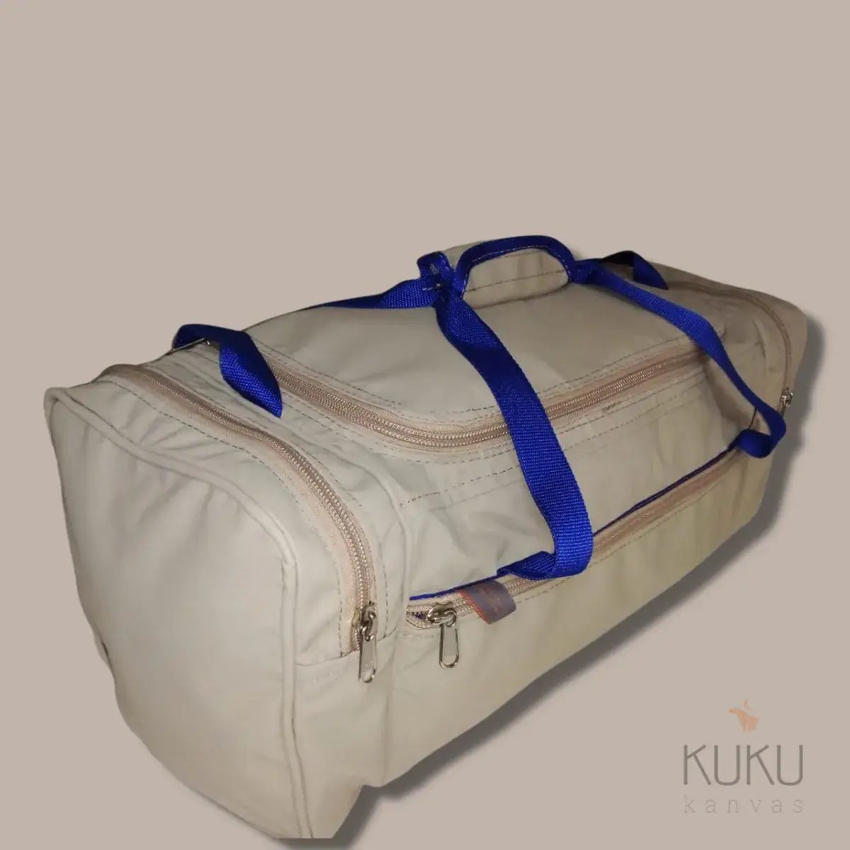 A white duffel bag with blue handles from kuku canvas