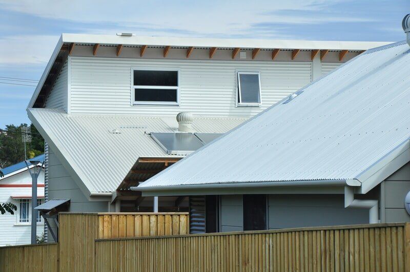 A White House with A Wooden Fence in Front of It — Mid Richmond Plumbers & Suppliers in Coraki, NSW