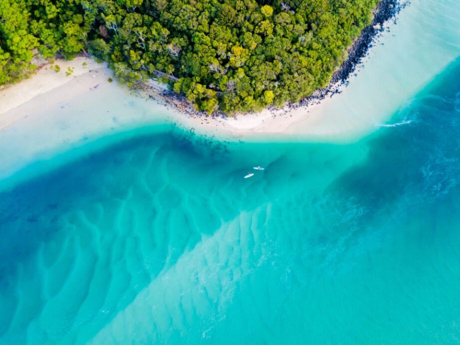 Aerial View of a Sandy Beach Meeting Turquoise and Blue Water — Mid Richmond Plumbers & Suppliers in Ocean Shores, NSW