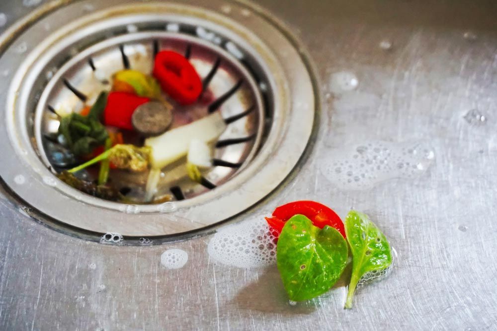 Kitchen Sink With Some Food Scraps