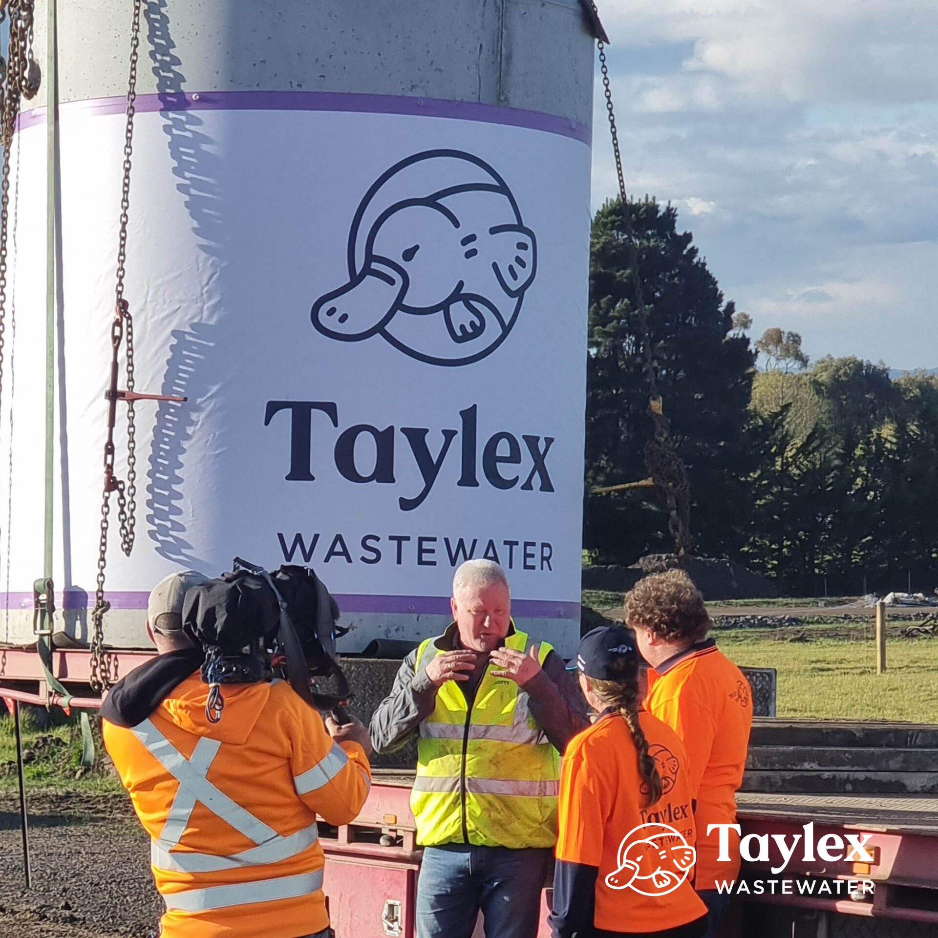 Group of People Standing in Front of A Signage that Says Taylex Wastewater — Mid Richmond Plumbers & Suppliers in Coraki, NSW