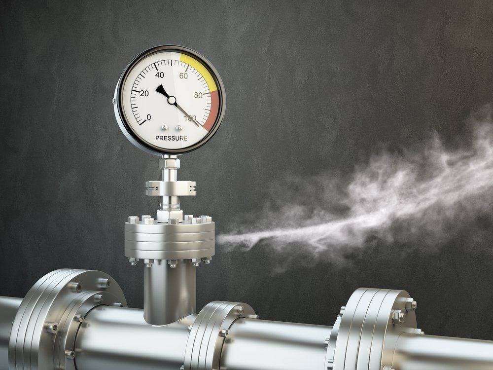 A Pressure Gauge on Top of a Metal Pipe With Smoke Coming Out of It — Mid Richmond Plumbers & Suppliers in Coraki, NSW