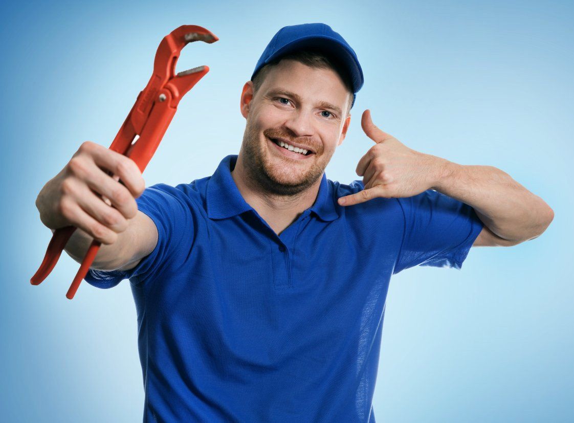 A Man is Holding a Wrench and Making a Call Me Gesture — Mid Richmond Plumbers & Suppliers in Coraki, NSW