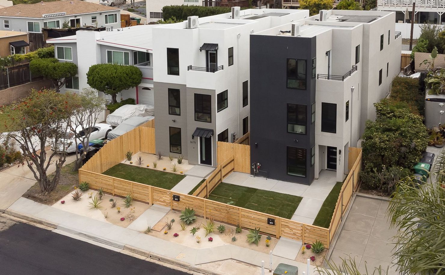 An aerial view of a building with a wooden fence around it