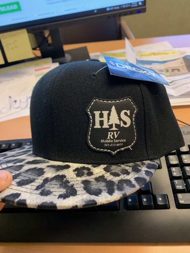 A person is holding a hat that says has on it