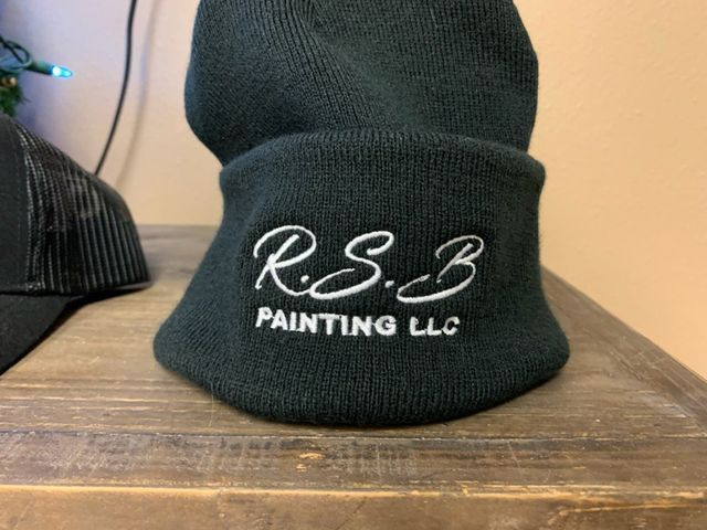 A black beanie that says rsb painting llc on it