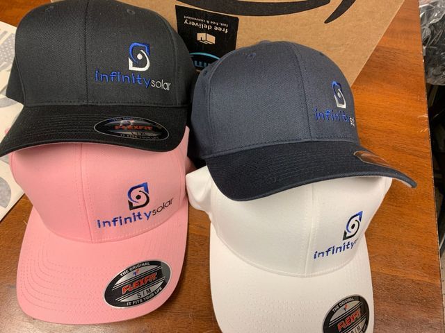 Three hats with infinity solar embroidered on them
