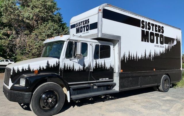 A black and white truck with the words sisters moto on it