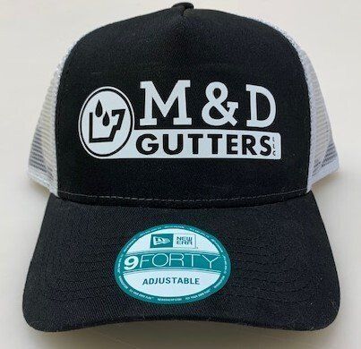 A black and white hat with the words m & d gutters on it.