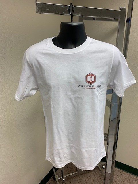 A white t-shirt is hanging on a rack on a mannequin.