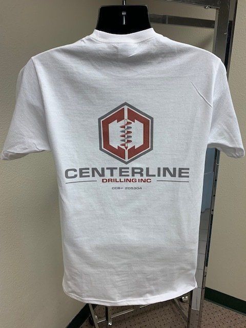A white centerline drilling t-shirt is hanging on a mannequin
