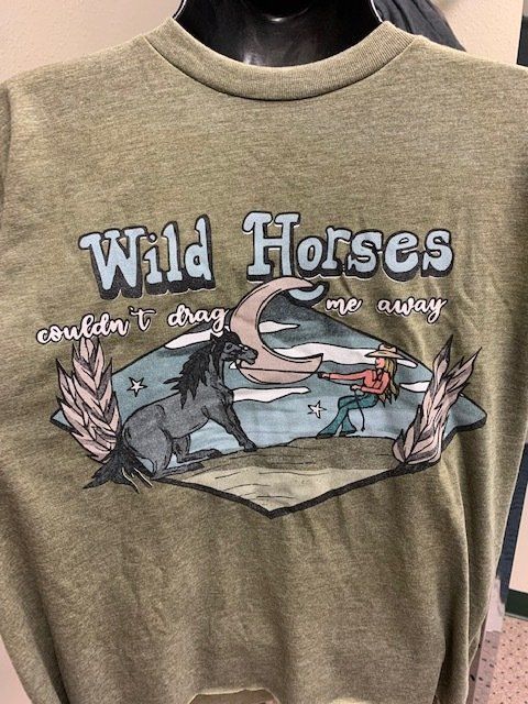A t-shirt with a picture of a horse and a woman on it.