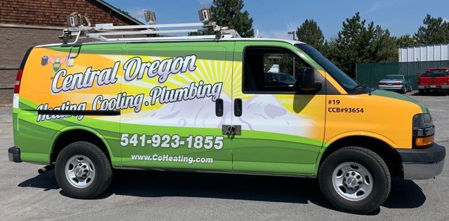 A green and yellow van for central oregon plumbing