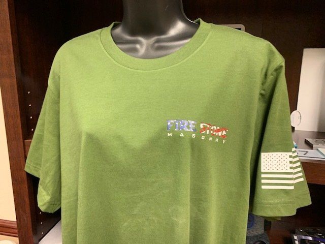 A green t-shirt with an american flag on the sleeve