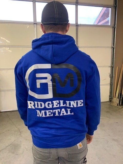 A man wearing a blue ridgeline metal hoodie