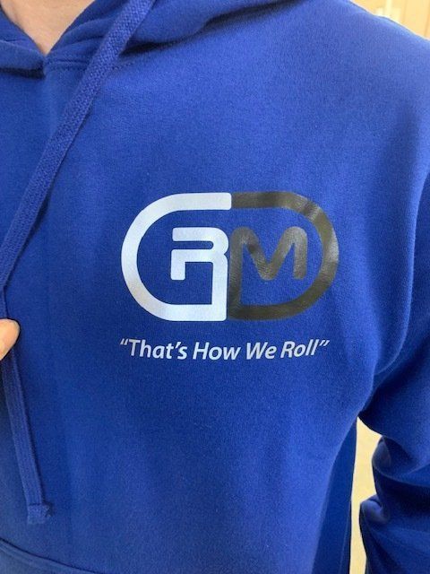 A person is wearing a blue hoodie that says 