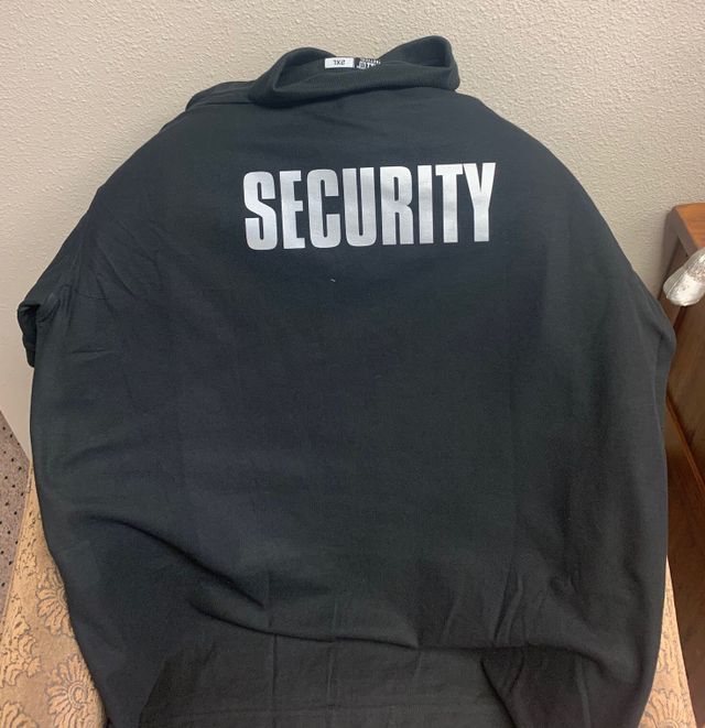 A black shirt with the word security on the back
