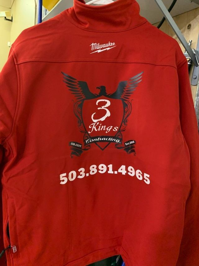 A red jacket that says 3 kings on it