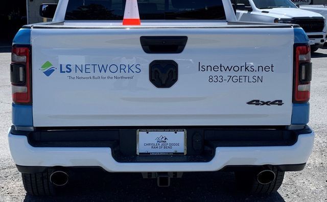 A white truck with ls networks written on the back